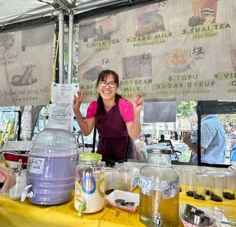 Lynh serving drinks at her festival booth